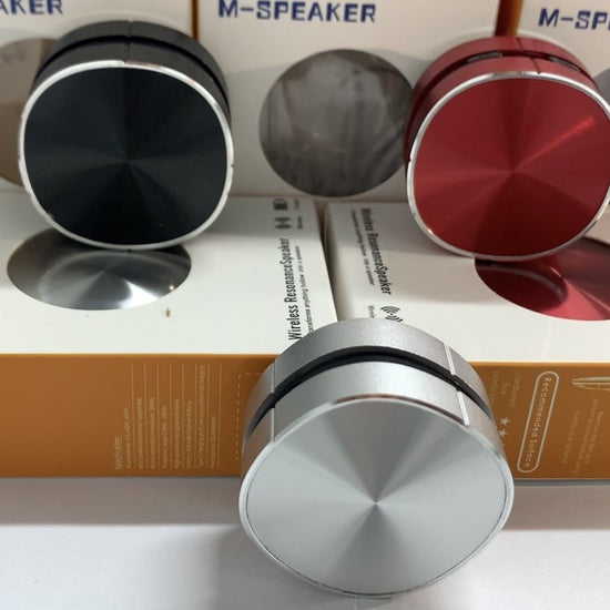Mini Speaker in black, red, and silver with packaging, showcasing portability and stylish design.