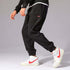 Mens Casual Pants in stylish black, paired with white and red Nike sneakers, perfect for casual outings.