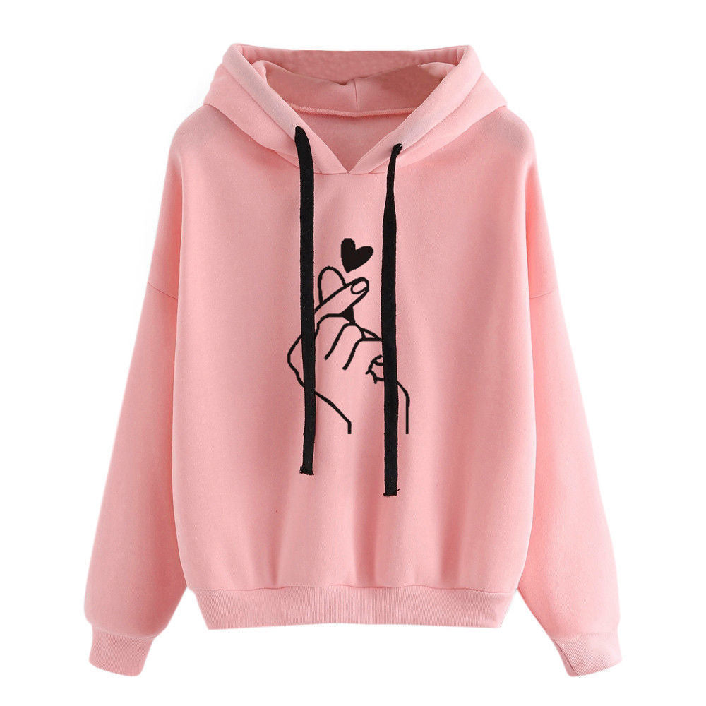 Fleece Hoodie in pink with heart print design and stylish finger gesture.
