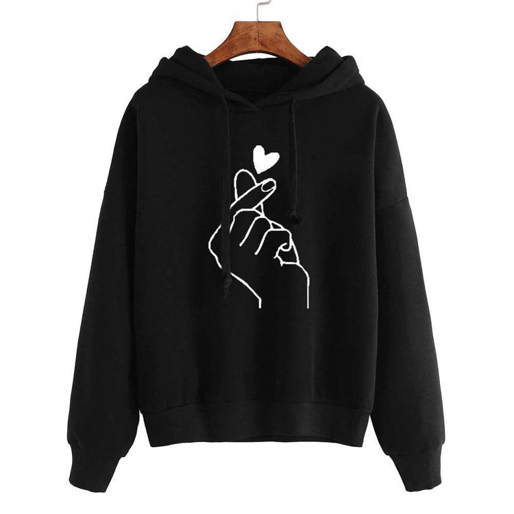 Fleece Hoodie with heart print design on black background, featuring stylish hand gesture.