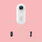 4K Thumb Camera – Ultra Compact in white with charging cable and accessory on a pink background.